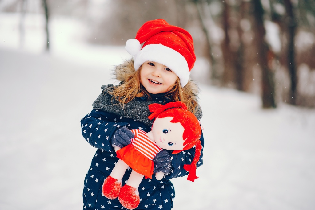 little-girl-in-a-blue-hat-playing-in-a-winter-forest.jpg